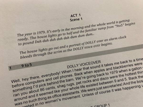 Close-up photo of a theater script page for the musical ‘9 to 5,’ showing Act 1, Scene 1 dialogue and stage directions printed on white paper.