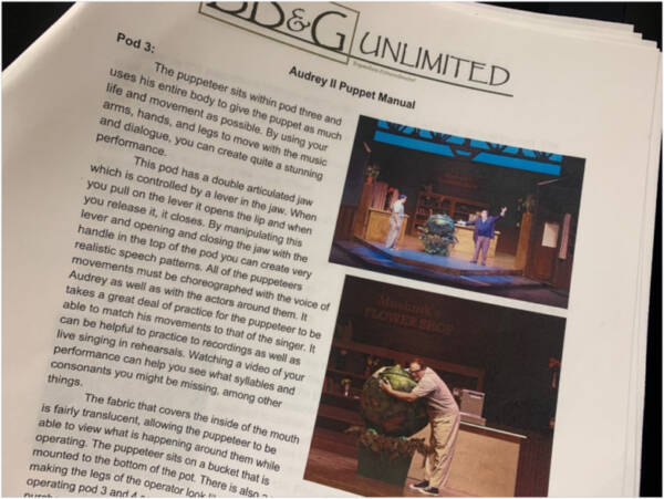 Open booklet page titled ‘Audry II Puppet Manual’ from SD&G Unlimited, featuring written instructions for operating a theater puppet alongside production photos showing performers manipulating the puppet on stage.